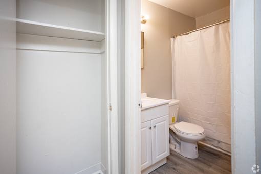 A white toilet sits in a small bathroom.