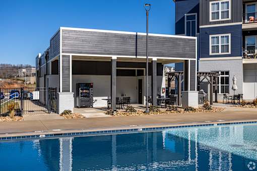 A modern house with a pool in front.