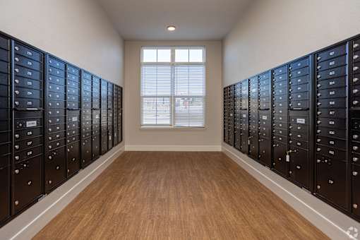 A room with a window and a row of mailboxes on the wall.