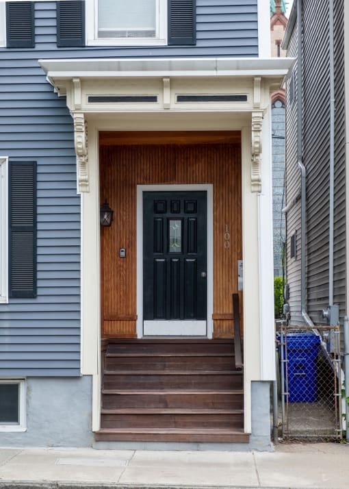 a blue house with a black door