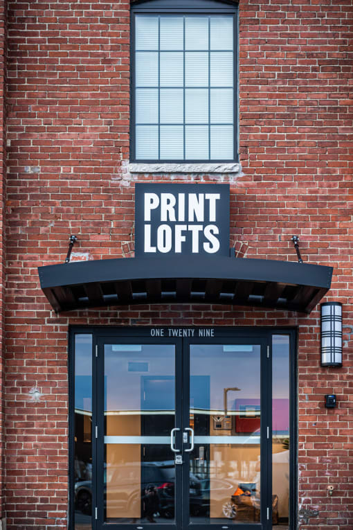 a brick building with a sign that reads print lofts
