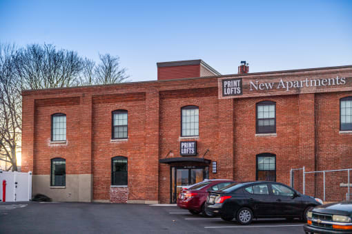 a red brick building with a sign that says point lobos new apartments