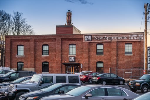a brick building with a sign that says new apartments