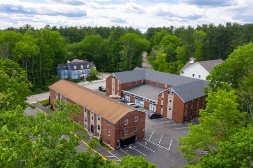 arial view of a red brick building with a brown roof