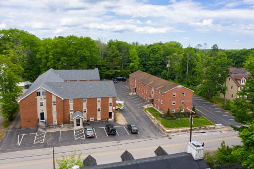arial view of a brick building with trees in the background