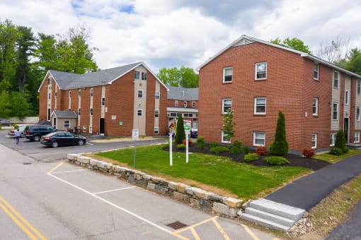 a large brick building with cars parked in front of it