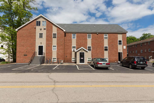 a large brick building with a parking lot in front of it