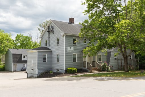 a large gray house with a gray roof