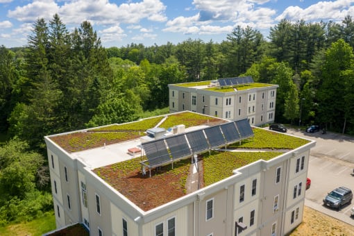 a building with a green roof and solar panels