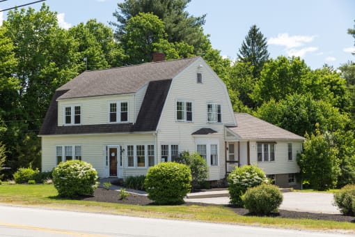 a house with a gray roof and white siding