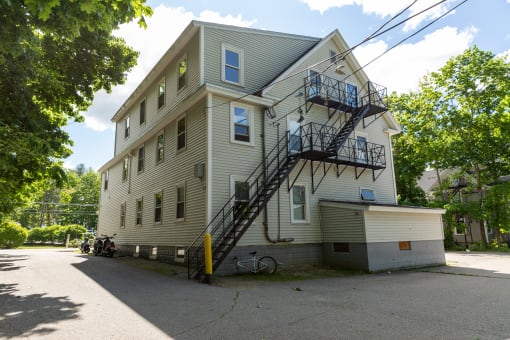 the back of the house with the parking lot in front of it