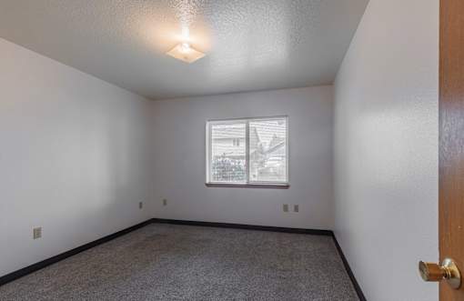 A room with a window and a door.