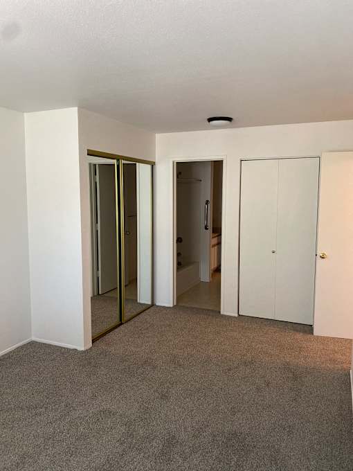 A white cabinet with a drawer is open.