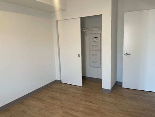 A white door with a control panel on the wall.
