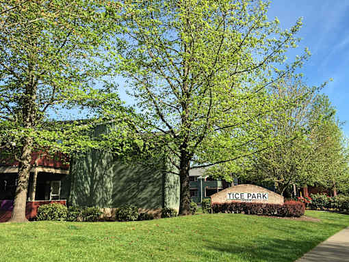 A sign that says Tice Park in front of a building.