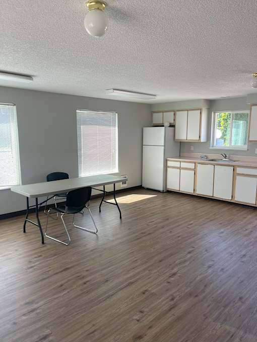 A room with a table and chairs in it.