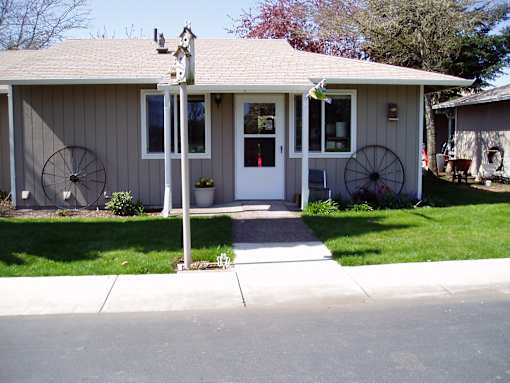 A house with a white door and two fans on the side.