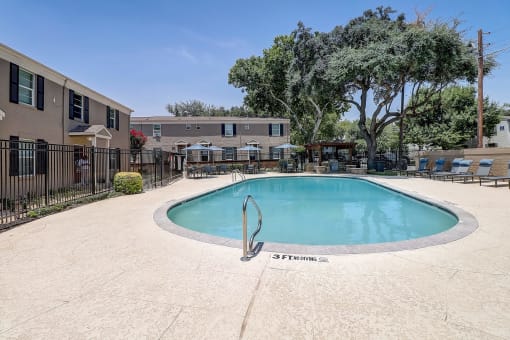 a resort style pool is next to an apartment building