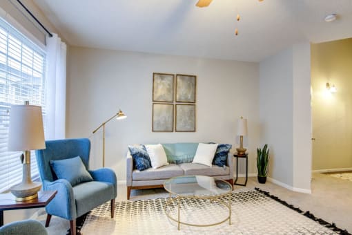 a living room with a couch chair and coffee table