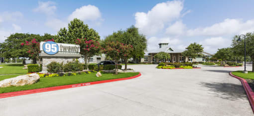 a driveway leading to a building with a sign that says 95 laurel