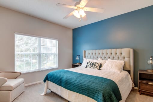 a bedroom with a bed and a ceiling fan