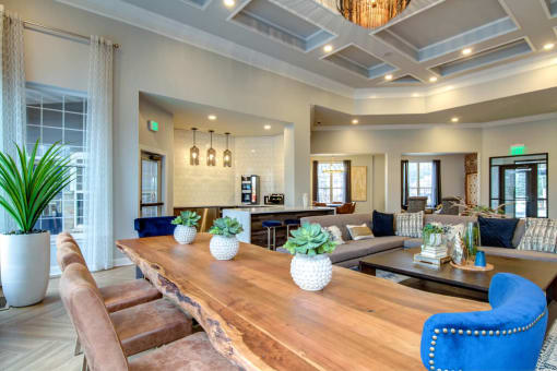a living room with a long wooden table and blue chairs