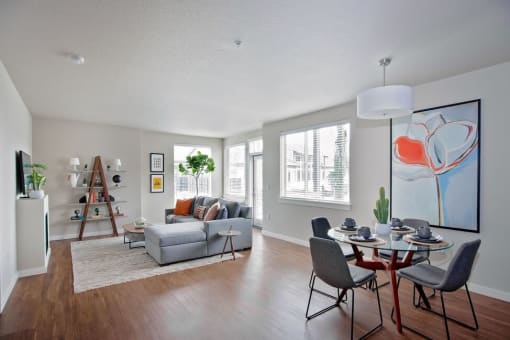 a living room with a couch and a table with chairs