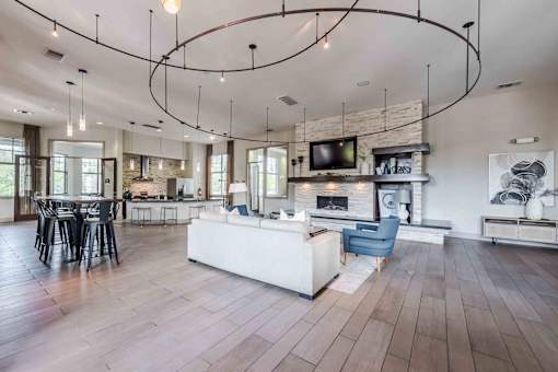 A modern living room with a fireplace and a TV mounted above it at 95twenty Apartments, Texas, 78717