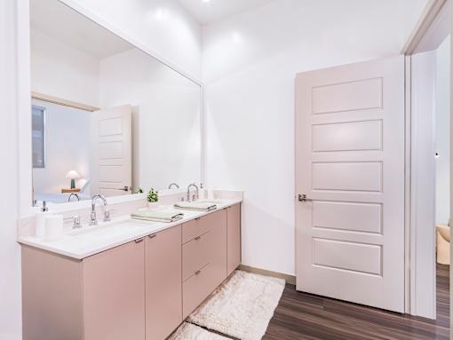A bathroom with a white sink and a white door.