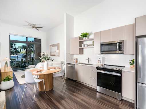 A modern kitchen with a dining table and chairs.