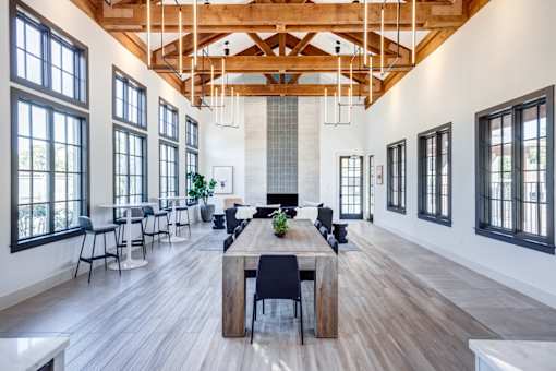 Resident lounge and co-working space with a long wooden table and chairs. at Barton Creek Villas, Austin, Texas