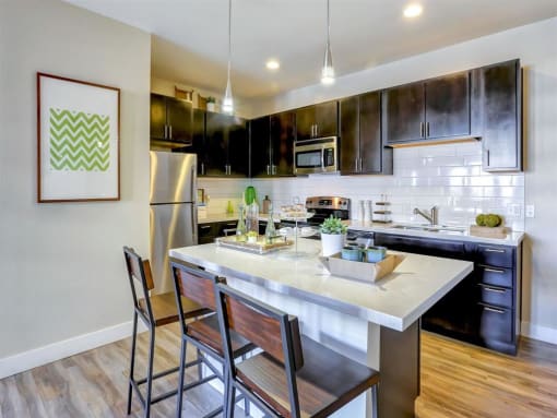 a kitchen with a large center island next to a stove top oven