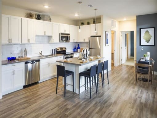 a kitchen with a center island next to a stove top oven