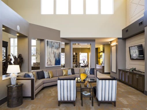 a living room filled with furniture and a large window