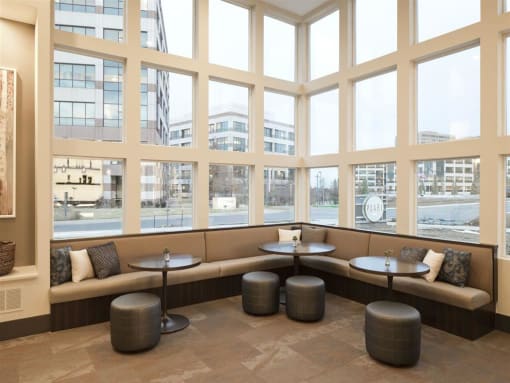 a large window with a row of tables and benches in front of it