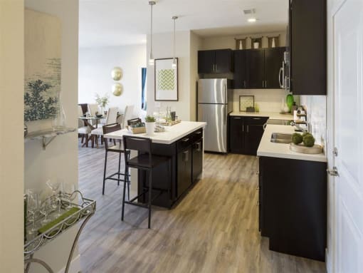 a kitchen with a large center island next to a dining room