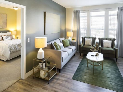 a living room filled with furniture and a large window