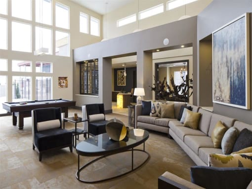a living room filled with furniture and a pool table