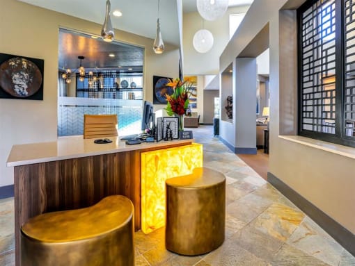 a hotel lobby with a bar and stools