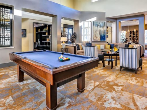 a large living room with a pool table in the middle of it