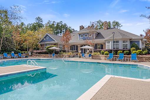 A large house with a pool in front.