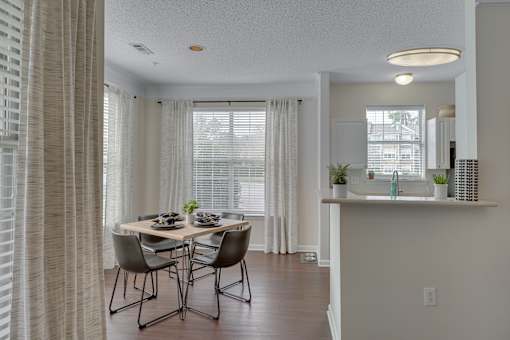 A dining room with a table set for four.