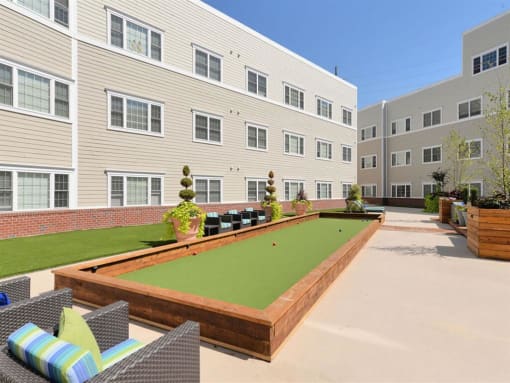 our apartments showcase an outdoor living area with a bocce court