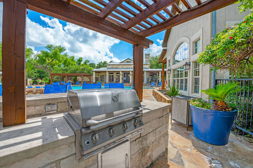 A patio with a grill and a pool table. at Barton Creek Villas, Austin, TX