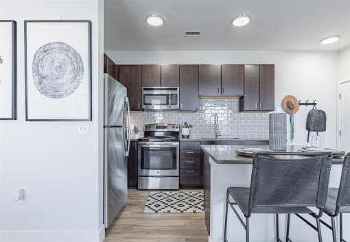 a kitchen with wooden cabinets and stainless steel appliances at RockVue, Broomfield, CO