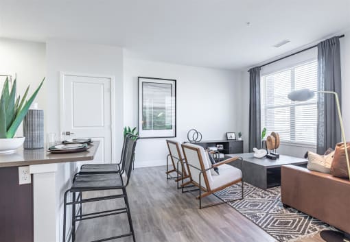 a living and dining area with white walls and hardwood flooring at RockVue, Broomfield