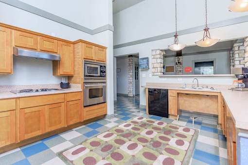 a kitchen with wooden cabinets and stainless steel appliances
