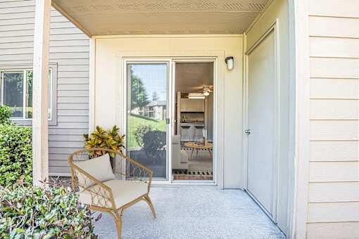 the front porch of a house with a chair and a door at Eagles Landing Apartments, Everett, 98204