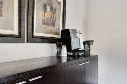 a coffee maker sitting on top of a cabinet in a hotel room at Eagles Landing Apartments, Everett, 98204