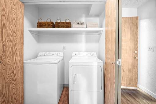 a small laundry room with two washes and a dryer at Eagles Landing Apartments, Everett, 98204